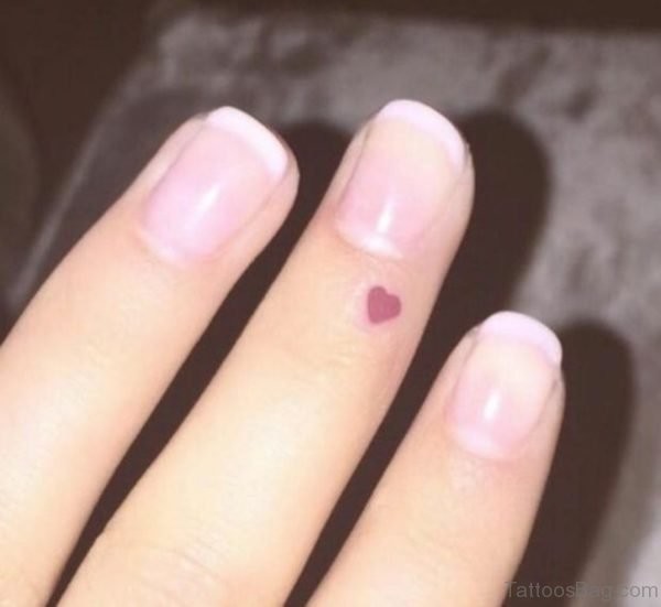 Tiny Red Heart On Finger Tattoo Idea