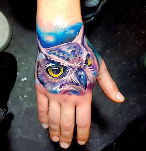Colorful Owl on Hand Tattoo Idea