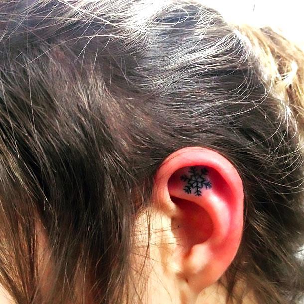 Cute Snowflake on Ear Tattoo Idea