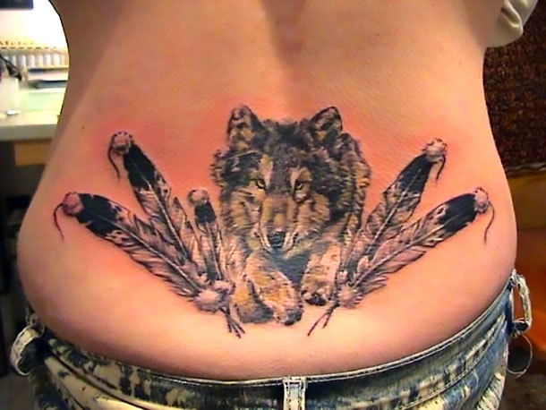 Wolf and Feathers on Lower Back Tattoo Idea