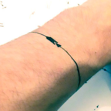 Wrap Around Arrow on Wrist Tattoo
