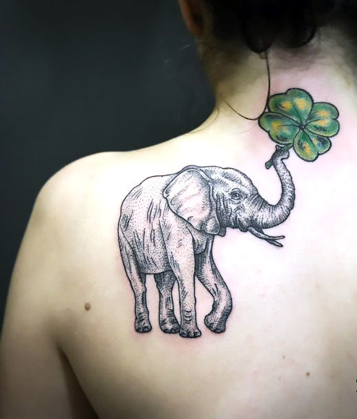 Elephant With Clover on Shoulder Blade Tattoo Idea