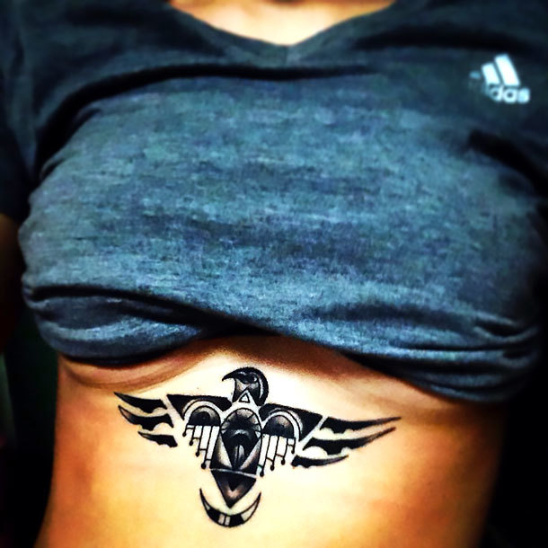 Thunderbird Under Breasts Tattoo Idea