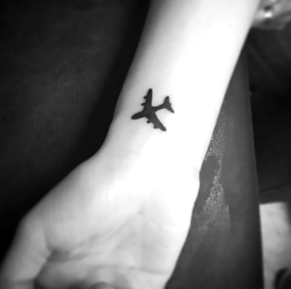 Simple Black Airplane Tattoo Idea