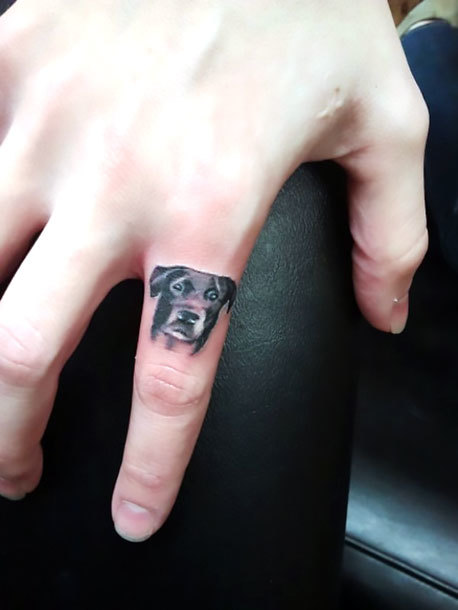 Small Dog on Finger Tattoo Idea
