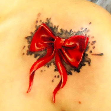 Small Bow on Shoulder Tattoo