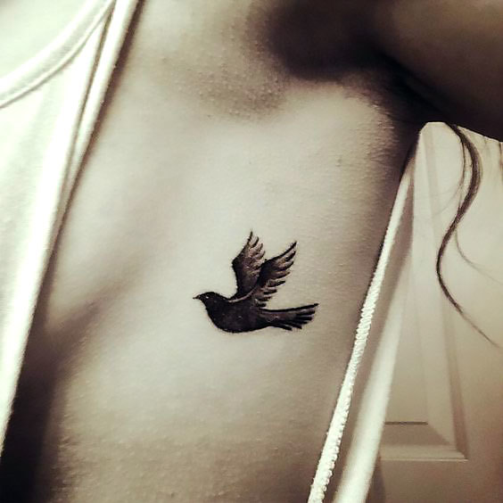 Small Blackbird on Ribs Tattoo Idea