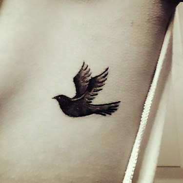 Small Blackbird on Ribs Tattoo