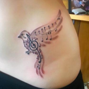 Small Songbird on Hip Tattoo