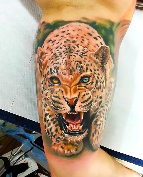 Jaguar With Different Eyes Tattoo on Bicep Tattoo Idea