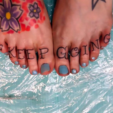 Keep Going Lettering on Toes Tattoo
